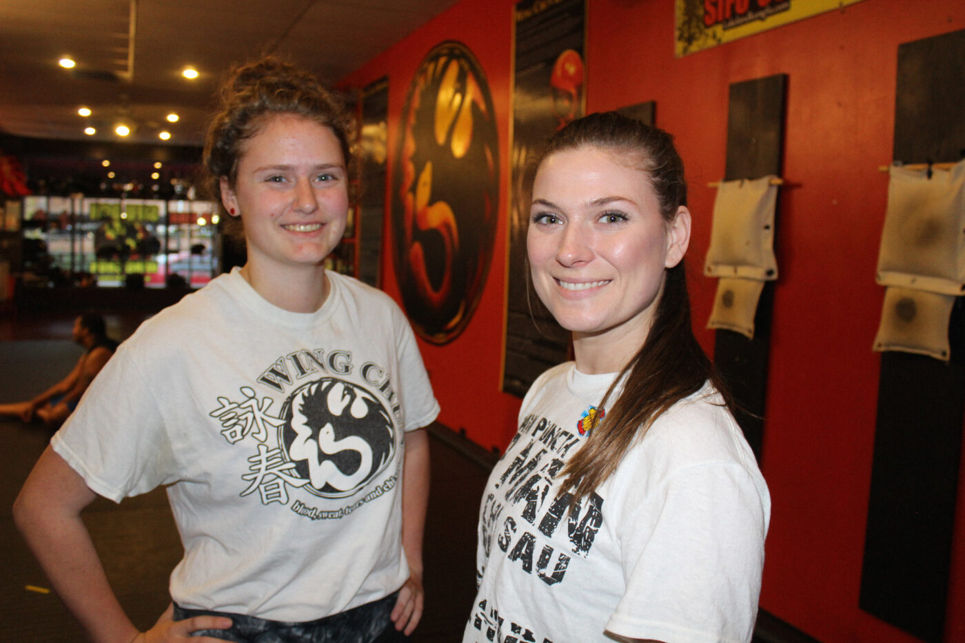 two women martial arts students smiling at the camera