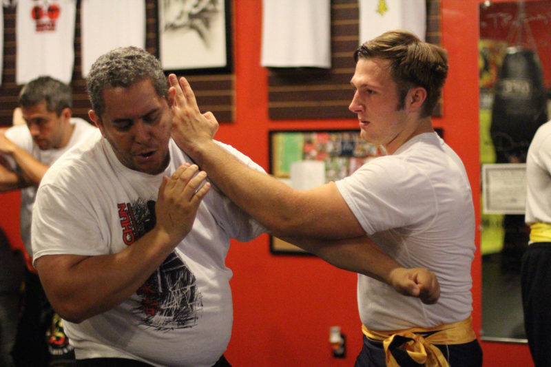 martial arts student hitting another with a wing chun chop technique