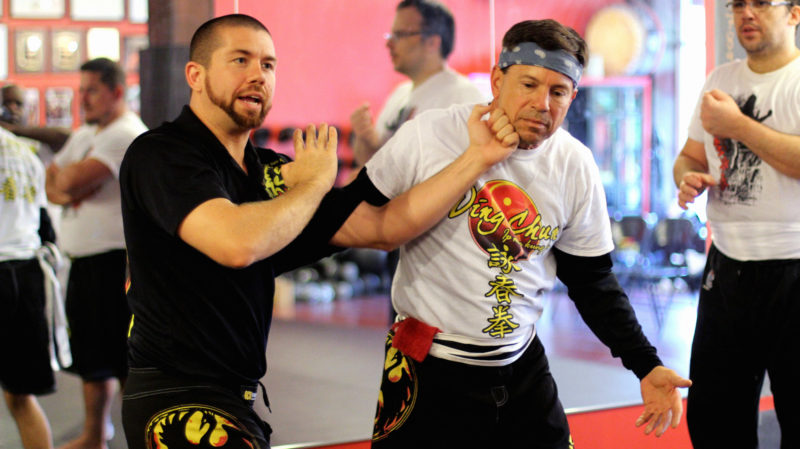 sifu justin och demonstrating a wing chun kung fu punch to a class of students