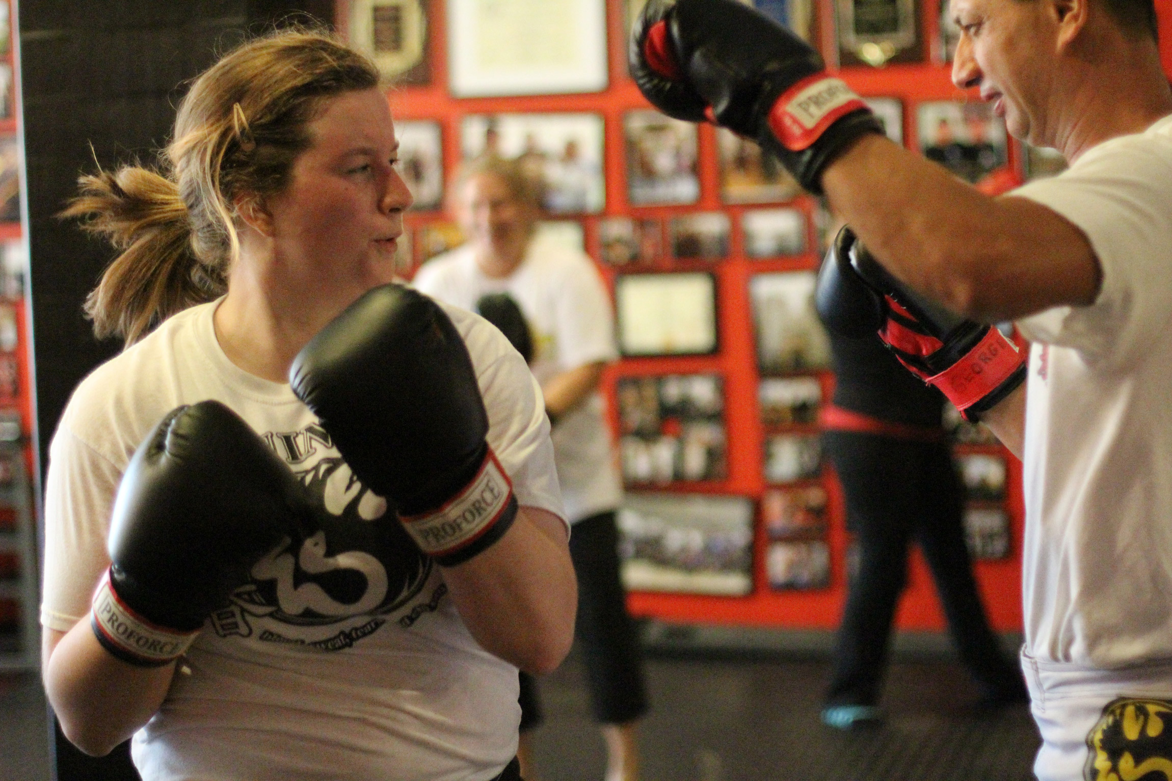woman doing kickboxing training wearing boxing gloves