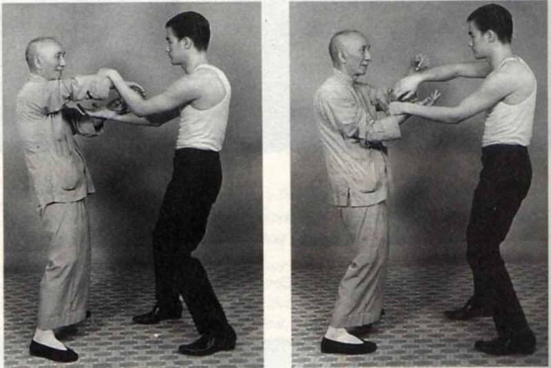 wing chun history image of ip man and bruce lee practicing chi sao