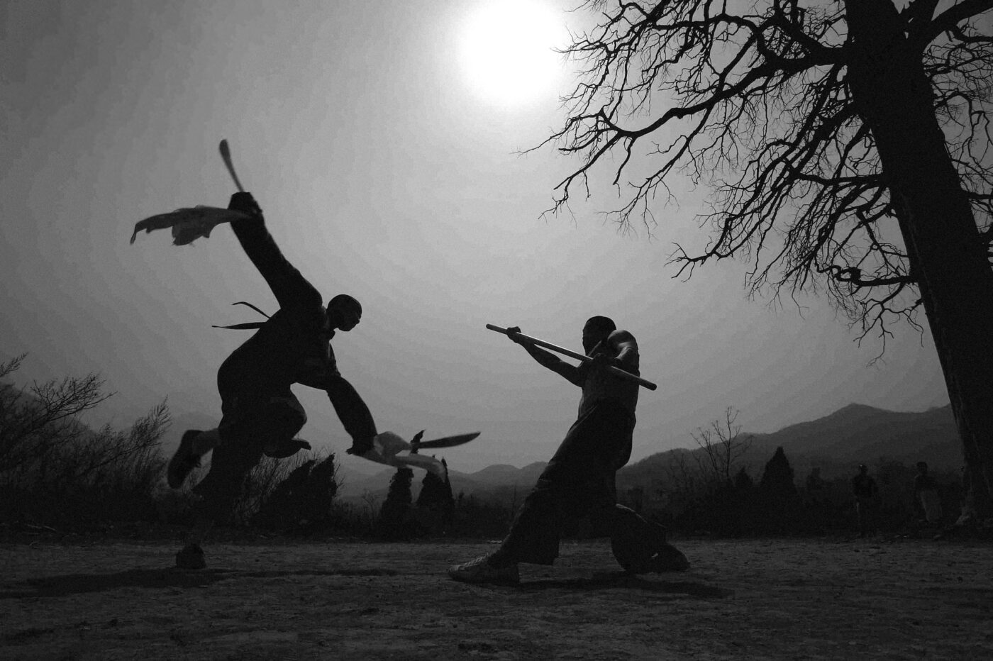 wing chun history photo, of two shaolin monks fighting with weapons