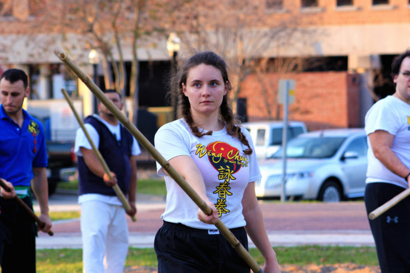 wing chun student using long pole during demonstration in downtown lakeland florida